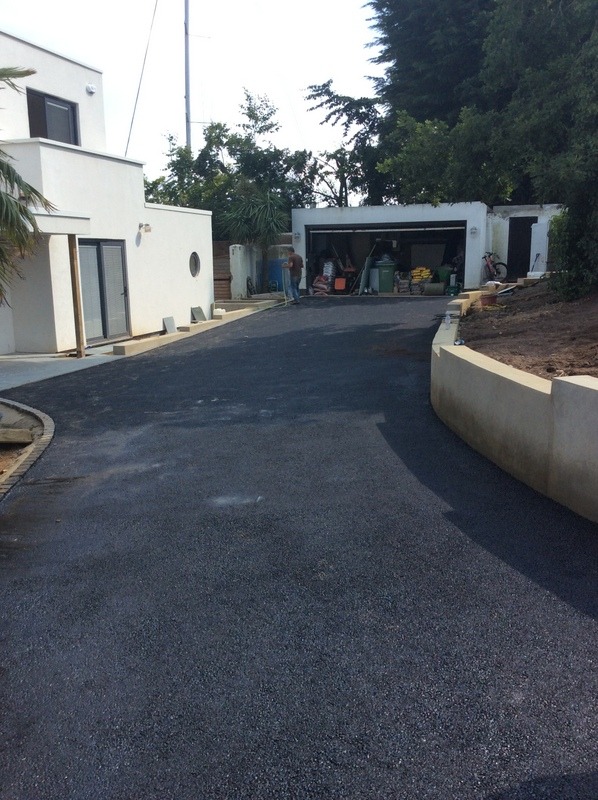 dark tarmac driveway in front of holiday house
